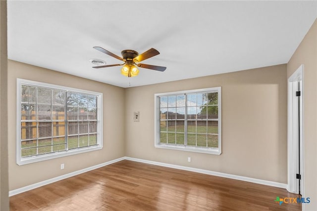 454 W Ward St, Goliad, TX 77963 - spare room with healthy amount of natural light, wood finished floors, and ceiling fan