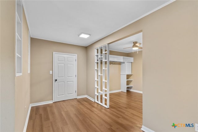 454 W Ward St, Goliad, TX 77963 - entryway with wood finished floors, ceiling fan, and crown molding