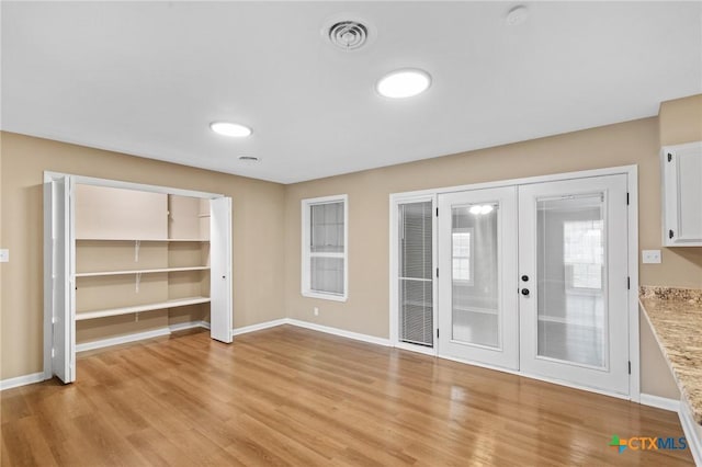 454 W Ward St, Goliad, TX 77963 - unfurnished dining area with french doors and light wood-type flooring