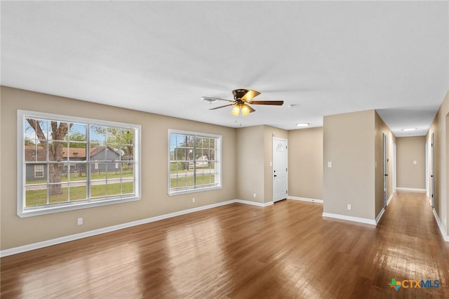 454 W Ward St, Goliad, TX 77963 - unfurnished living room with wood finished floors and ceiling fan