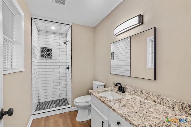 454 W Ward St, Goliad, TX 77963 - bathroom featuring a stall shower, vanity, and wood finished floors