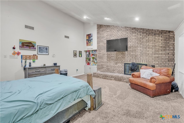 carpeted bedroom with vaulted ceiling and a fireplace