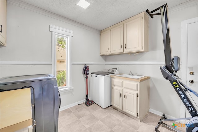 laundry area featuring cabinets, a wealth of natural light, a textured ceiling, and washer / clothes dryer