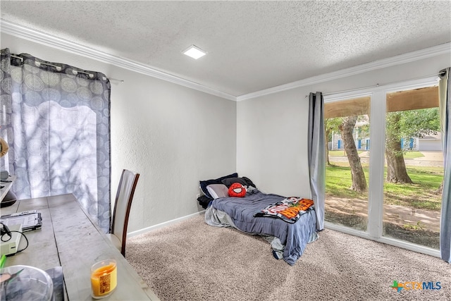 carpeted bedroom featuring access to exterior, a textured ceiling, and ornamental molding