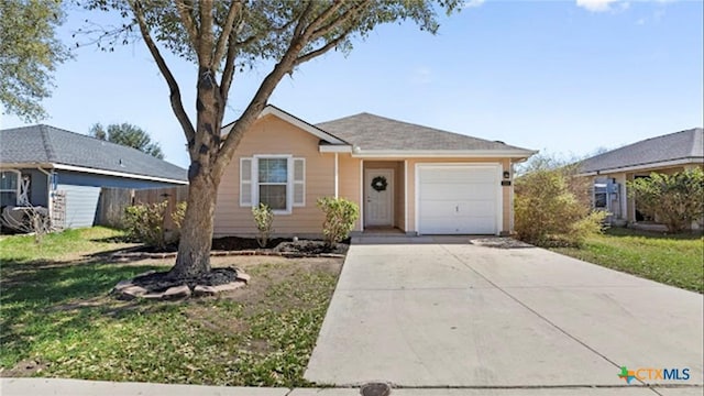 ranch-style home with concrete driveway, an attached garage, and a front yard