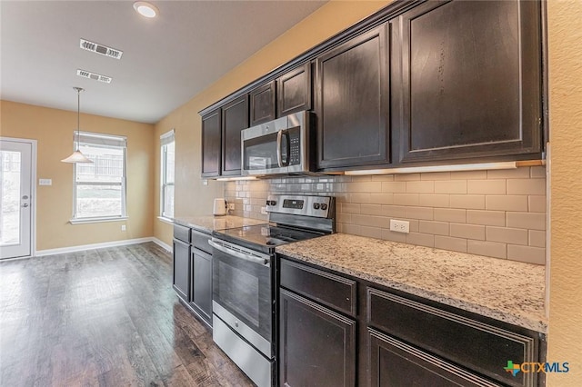 1233 Jester Ct, Copperas Cove, TX 76522 - kitchen with stainless steel appliances, visible vents, light stone counters, and dark wood-type flooring