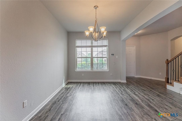 1233 Jester Ct, Copperas Cove, TX 76522 - unfurnished dining area featuring arched walkways, dark wood finished floors, baseboards, a notable chandelier, and stairs