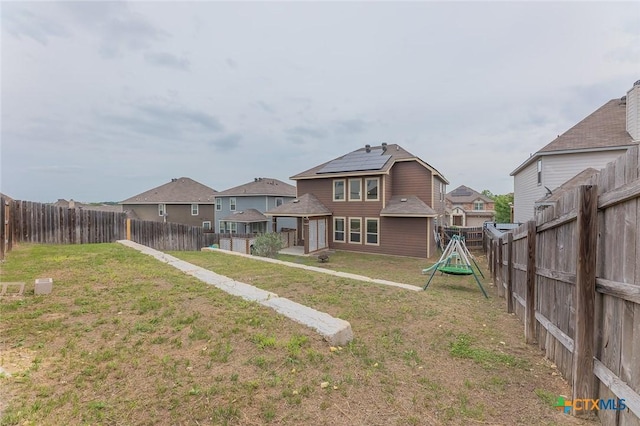 1233 Jester Ct, Copperas Cove, TX 76522 - rear view of house with a yard, a residential view, a fenced backyard, and a playground