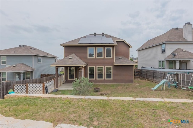 1233 Jester Ct, Copperas Cove, TX 76522 - rear view of property featuring a patio, a fenced backyard, a playground, a yard, and solar panels