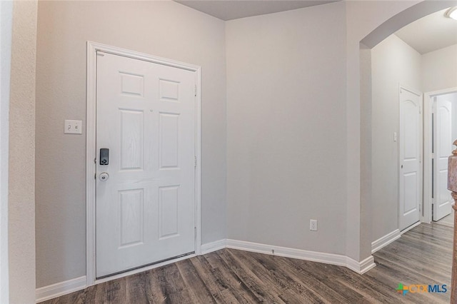 1233 Jester Ct, Copperas Cove, TX 76522 - foyer with arched walkways, baseboards, and dark wood-type flooring