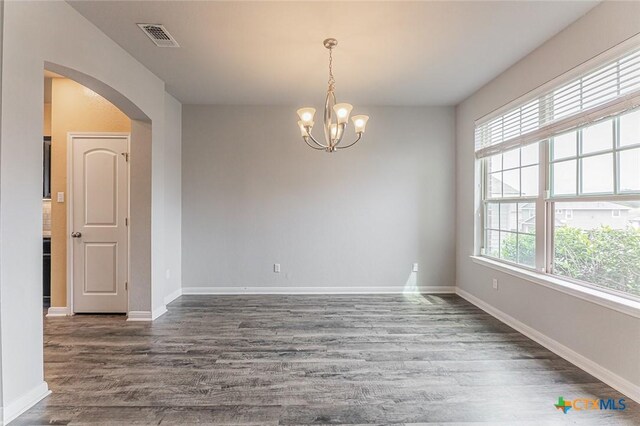 1233 Jester Ct, Copperas Cove, TX 76522 - empty room featuring visible vents, arched walkways, wood finished floors, and a chandelier