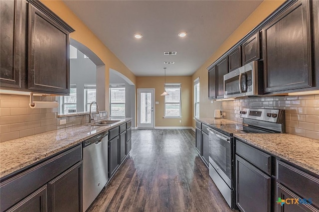 1233 Jester Ct, Copperas Cove, TX 76522 - kitchen with dark brown cabinetry, visible vents, appliances with stainless steel finishes, dark wood finished floors, and a sink