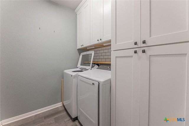 1233 Jester Ct, Copperas Cove, TX 76522 - laundry room with baseboards, wood finished floors, cabinet space, and washer and clothes dryer