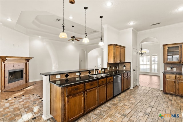 kitchen with stainless steel dishwasher, visible vents, arched walkways, and a sink