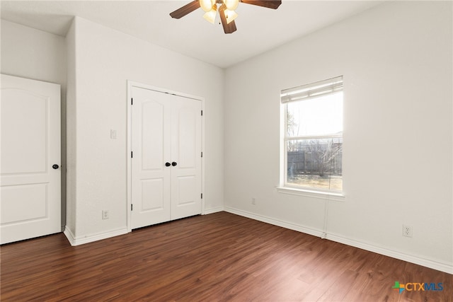 unfurnished bedroom with a closet, ceiling fan, baseboards, and wood finished floors