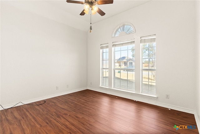 unfurnished room featuring baseboards, a ceiling fan, and wood finished floors