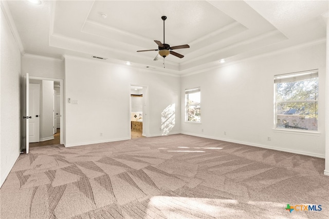 unfurnished bedroom featuring baseboards, a raised ceiling, carpet, and ornamental molding