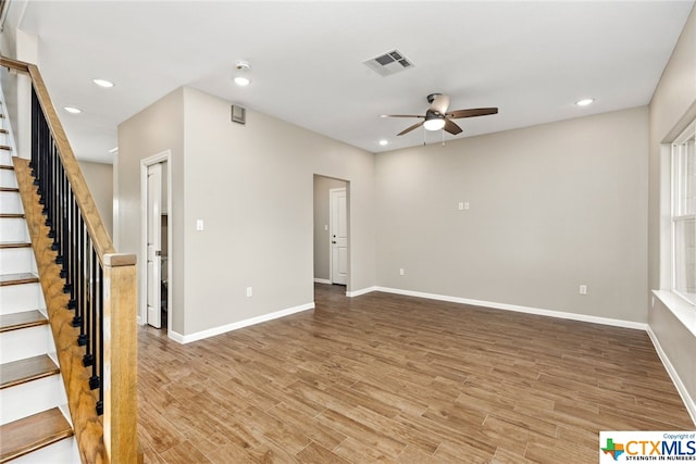 spare room with ceiling fan and wood-type flooring