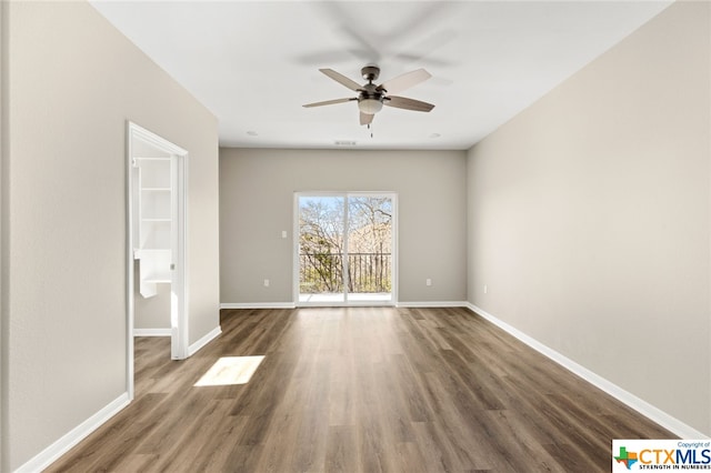 unfurnished room with ceiling fan and dark hardwood / wood-style floors