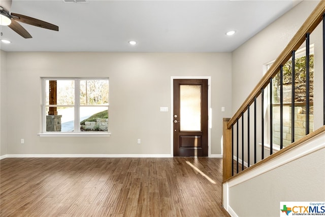 foyer with a wealth of natural light, hardwood / wood-style floors, and ceiling fan