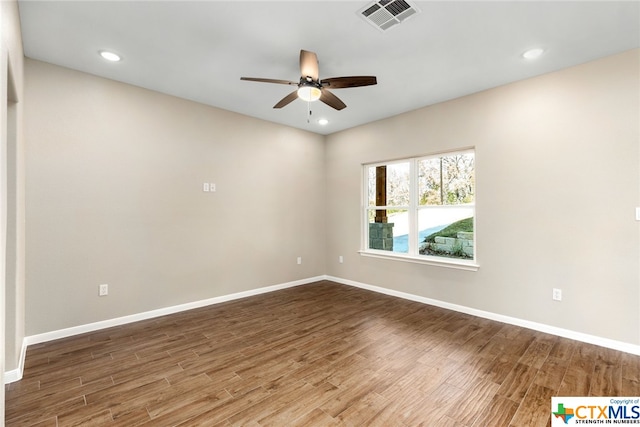 unfurnished room with ceiling fan and hardwood / wood-style floors