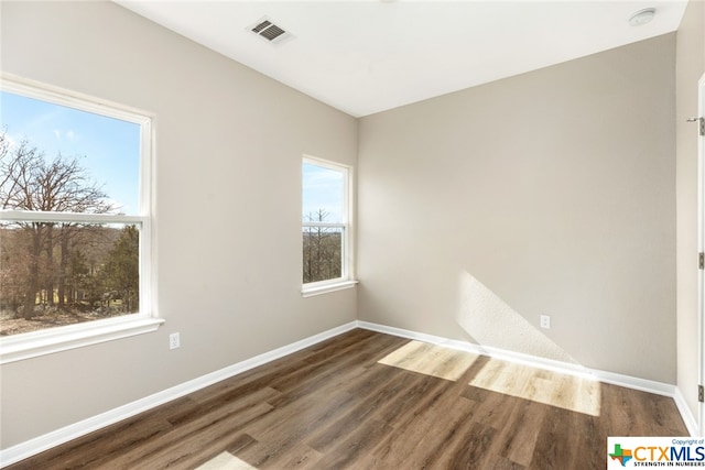 spare room featuring dark hardwood / wood-style floors