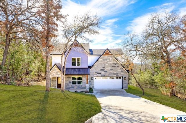 view of front of home with a front yard and a garage