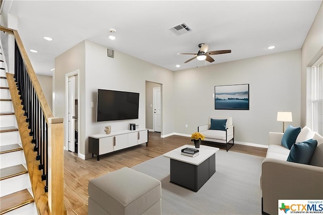 living room with hardwood / wood-style flooring and ceiling fan