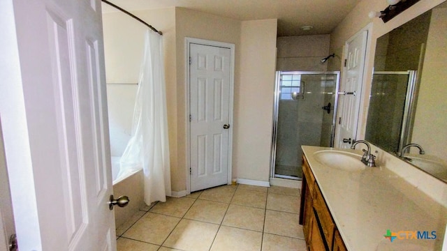 bathroom featuring tile patterned flooring, an enclosed shower, and vanity