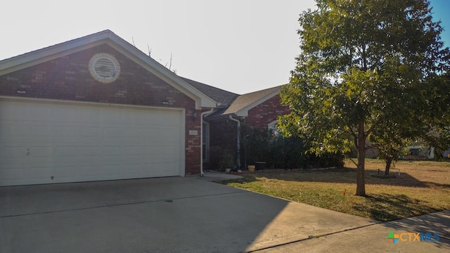 single story home featuring a garage and a front lawn