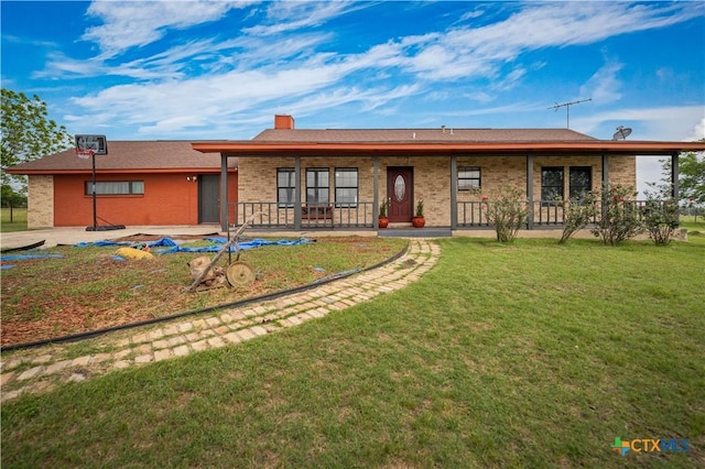 ranch-style home featuring brick siding, a front yard, and a chimney
