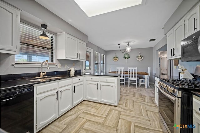 kitchen featuring black dishwasher, stainless steel range with gas cooktop, a sink, dark countertops, and white cabinetry