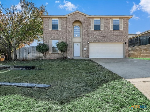 view of front of home featuring a front yard and a garage