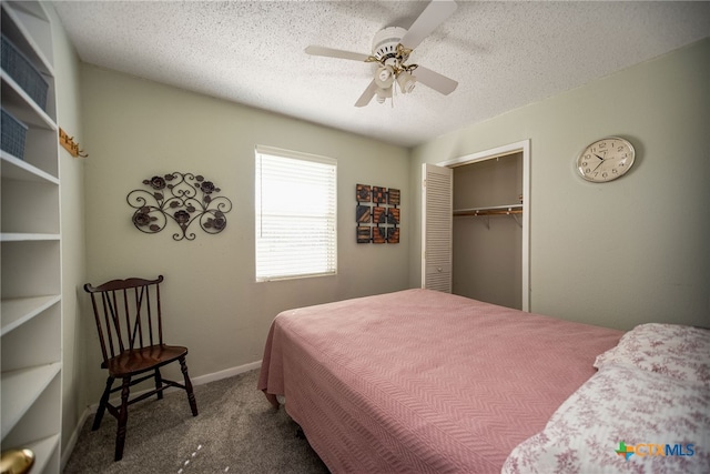 carpeted bedroom with a closet, a textured ceiling, and ceiling fan