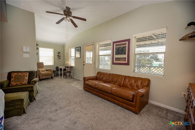 living room with lofted ceiling, a textured ceiling, light carpet, and ceiling fan