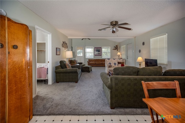 carpeted living room featuring a textured ceiling and ceiling fan