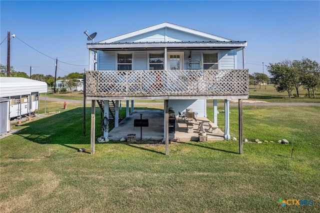 rear view of house with a yard and a patio area