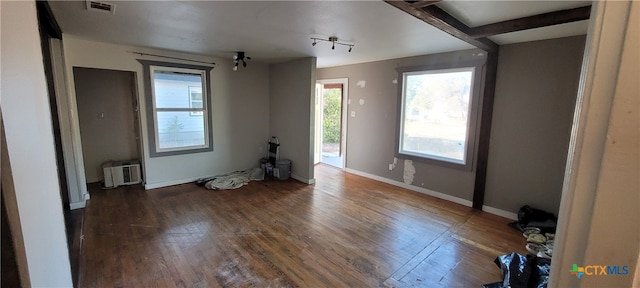 interior space with beam ceiling and dark hardwood / wood-style floors