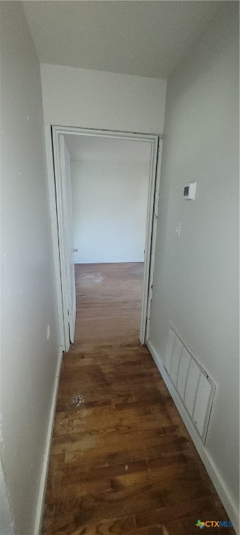 hallway with dark hardwood / wood-style flooring