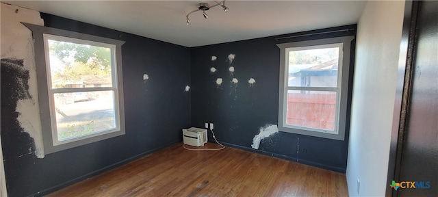 spare room with wood-type flooring