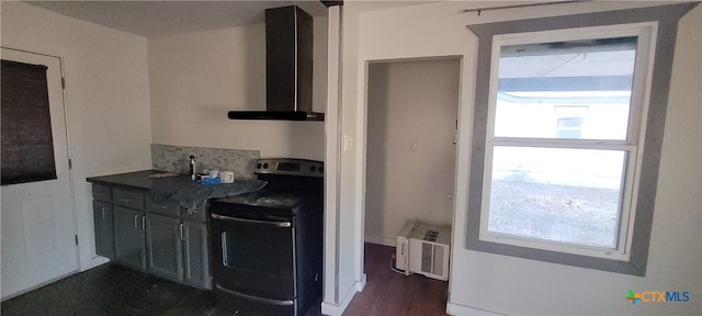 kitchen featuring electric range, plenty of natural light, wall chimney exhaust hood, and dark wood-type flooring