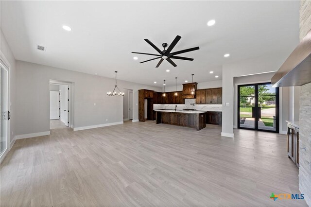 644 Creekside Dr, Belton, TX 76513 - unfurnished living room featuring a ceiling fan, recessed lighting, a chandelier, light wood-type flooring, and a fireplace