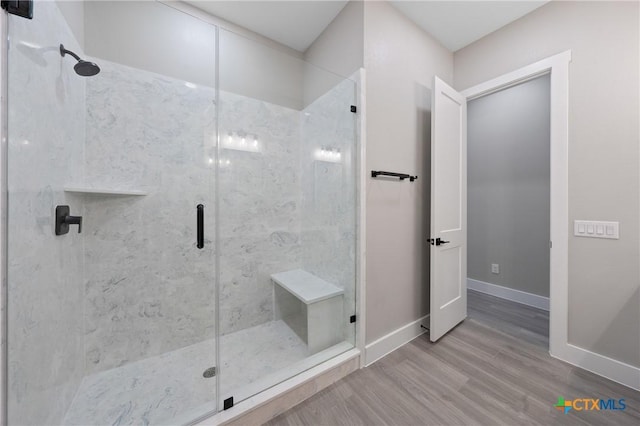 644 Creekside Dr, Belton, TX 76513 - bathroom featuring a stall shower, wood finished floors, and baseboards