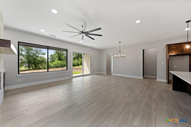 644 Creekside Dr, Belton, TX 76513 - unfurnished living room featuring a chandelier, ceiling fan, light wood finished floors, a fireplace, and recessed lighting