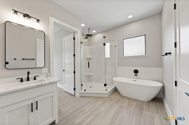 644 Creekside Dr, Belton, TX 76513 - bathroom with a shower stall, vanity, a freestanding tub, recessed lighting, and wood finished floors