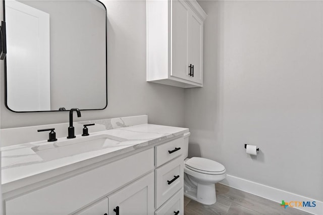 644 Creekside Dr, Belton, TX 76513 - half bath with toilet, vanity, baseboards, and wood finished floors