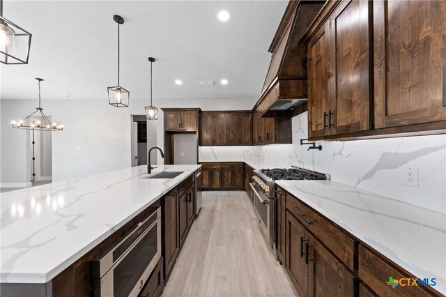 644 Creekside Dr, Belton, TX 76513 - kitchen featuring stainless steel appliances, a sink, light wood finished floors, recessed lighting, and a chandelier