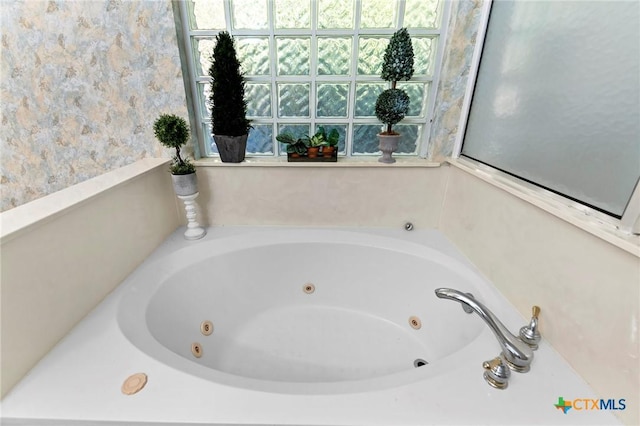 full bath featuring a jetted tub and plenty of natural light