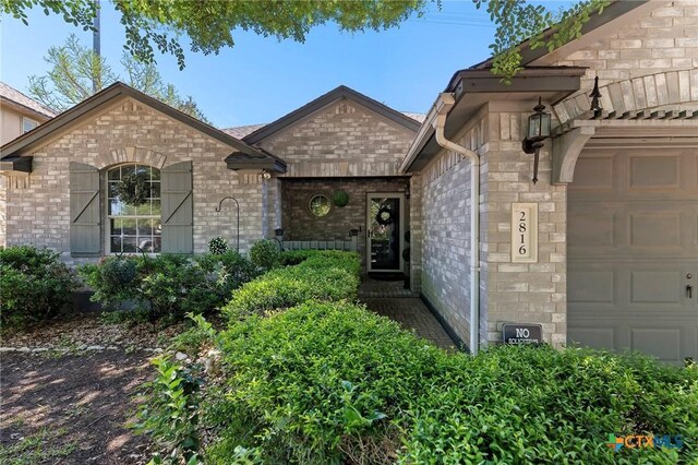 2816 Bluejay Dr, Cedar Park, TX 78613 - view of front of property with an attached garage, brick siding, and stone siding