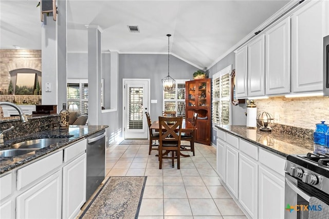 kitchen featuring sink, appliances with stainless steel finishes, white cabinetry, ornamental molding, and light tile patterned flooring